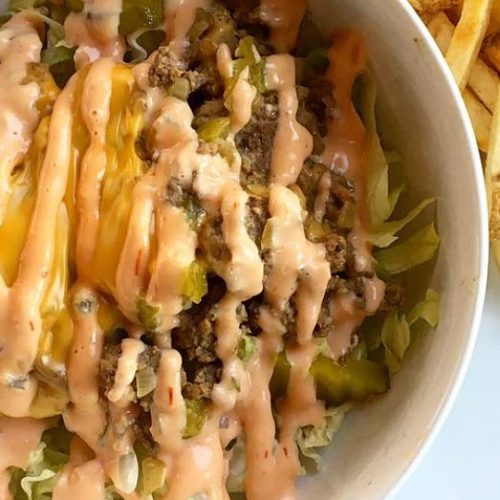 Big Mac salad in a bowl with fries on the side