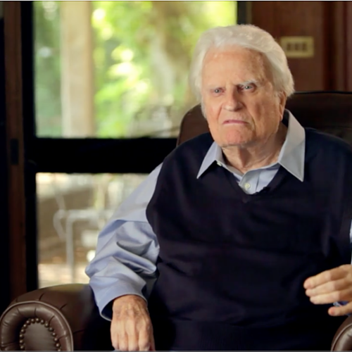 Billy Graham sitting in a brown leather chair