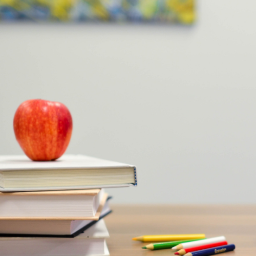 books stacked with an apple on top
