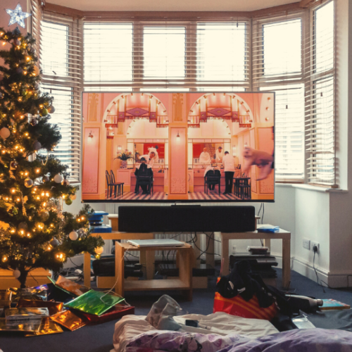 Living Room with Christmas tree and Christmas movie on TV