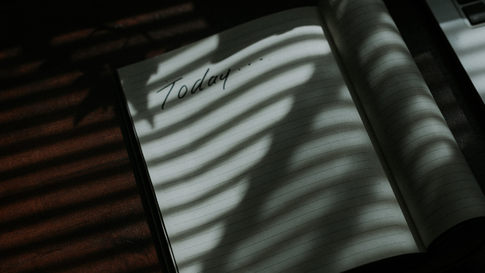 blank white journal with the word Today scribbled at the top of the page and the shadow of a window over it