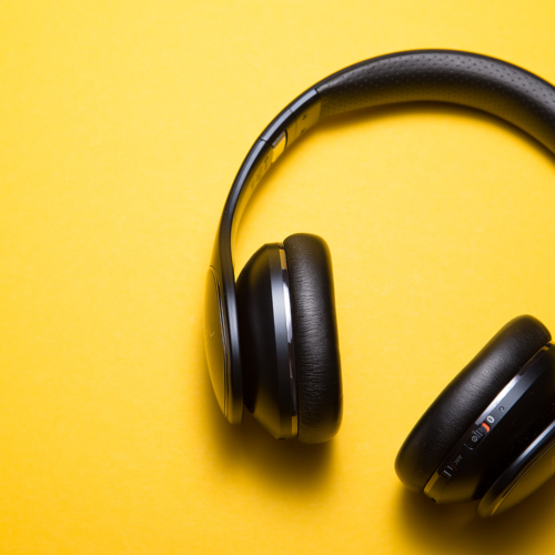 black headphones on yellow background