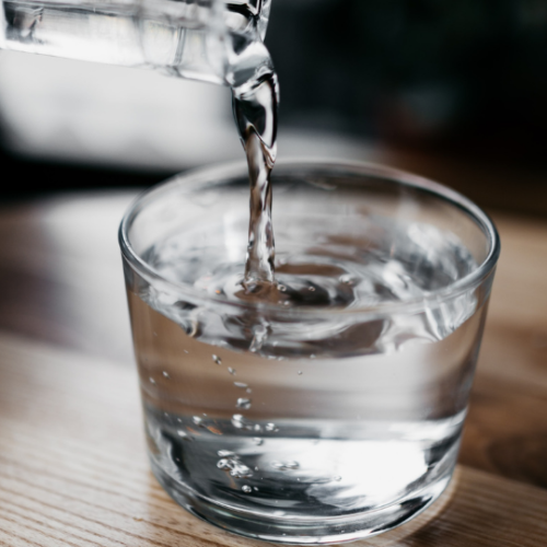 water being poured into a clear glass