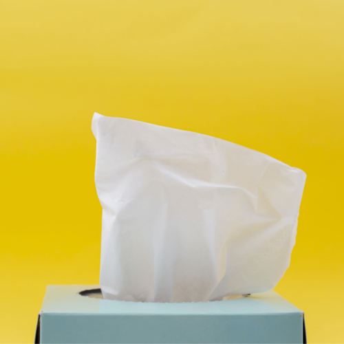 pale blue tissue box sitting in front of a yellow background