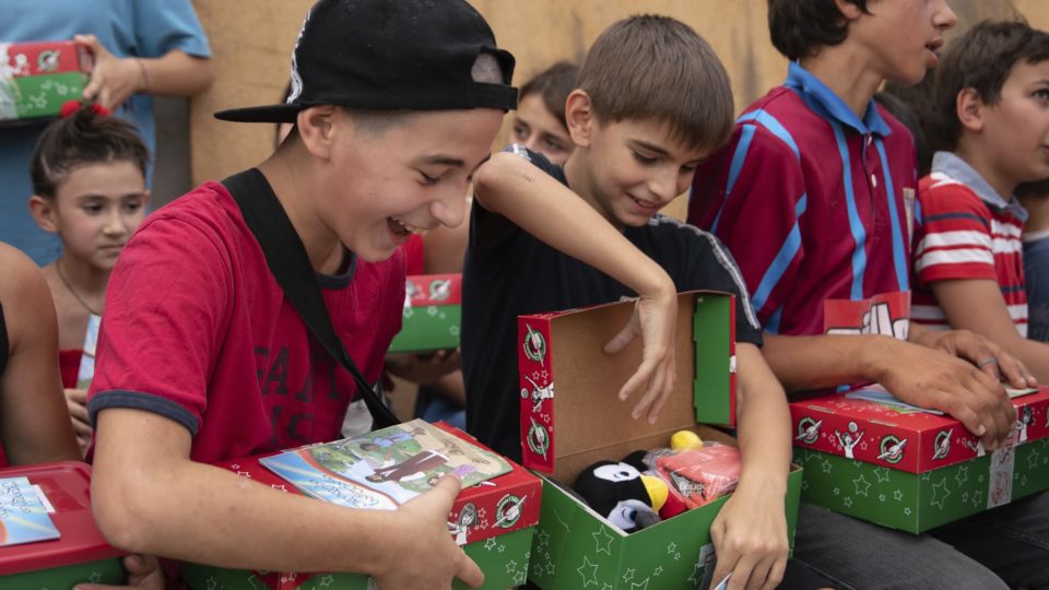 Boys in the Caucasus nation of Georgia rejoice to receive shoebox gifts and The Greatest Gift Gospel booklets.
