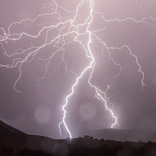 lightning bolt striking near mountain