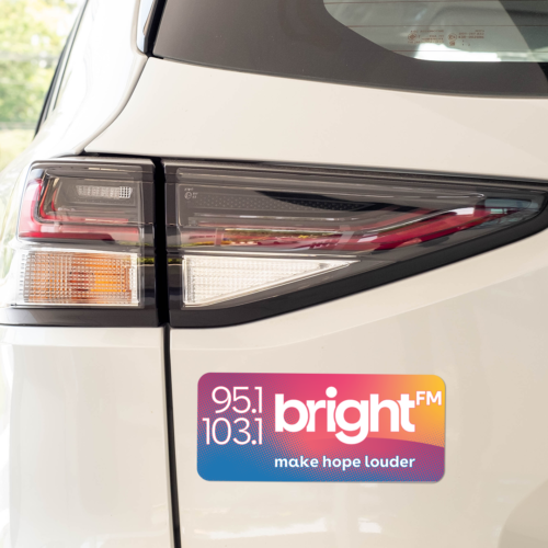 BRIGHT-FM car magnet on the bumper of a white car