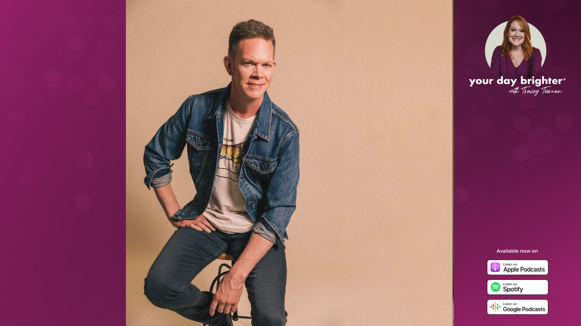 Jason Gray wearing a white tshirt and blue denim jacket while smiling and sitting on a stool against a tan background