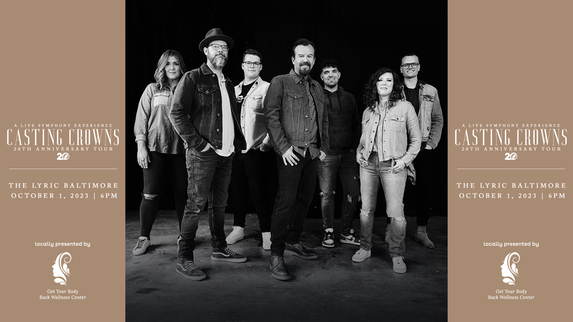 Black and white photo of the seven members of Casting Crowns standing side by side as they smile in front of a black backdrop