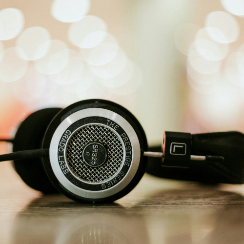 black corded headphones with dappled light background